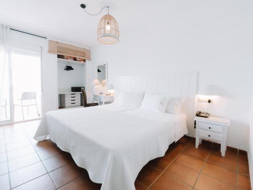 Postel nebo postele na pokoji v ubytování Hostal del Cabo