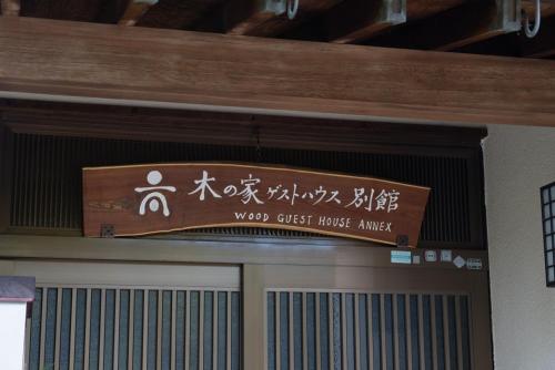 a sign on the top of a door in a building at 木の家ゲストハウス別館 in Mito