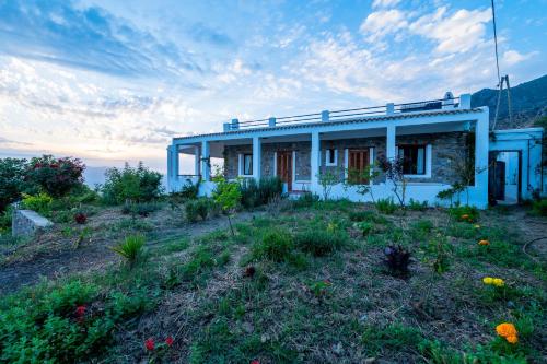 a house on top of a hill with a field at Farm Finn in Chefchaouene