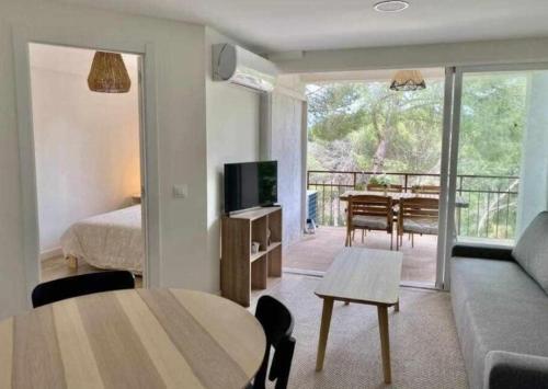 - un salon avec un lit, une table et une télévision dans l'établissement Flat with lake views - Pantano San Juan - 21, à Madrid