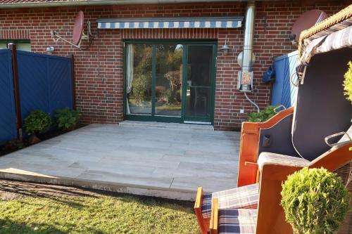 a front door of a house with a patio at Ferienhaus Blomengoorn in Redewisch