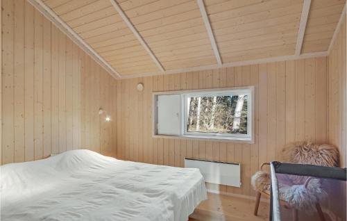 a bedroom with a bed in a room with a window at 2 Bedroom Gorgeous Home In Føllenslev in Føllenslev