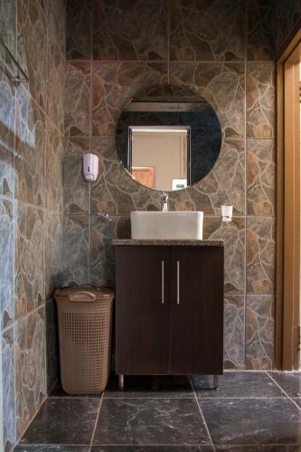 a bathroom with a sink and a mirror at Bush Inn Lodge Lephalale in Lephalale