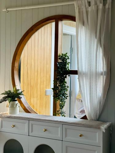 a mirror on top of a dresser in a room at บ้านไร่ฟ้าสวย Nordic 02 in Ban Kom