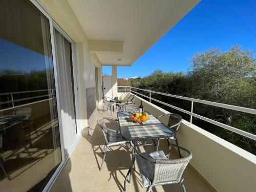 a balcony with a table and chairs on a balcony at Nissi Beach beautiful apartment in Ayia Napa