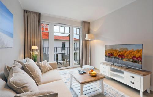 a living room with a couch and a flat screen tv at Baltischer Hof Apartment 39 in Boltenhagen