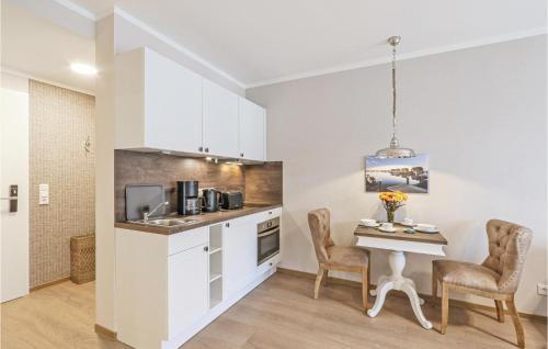 a kitchen with a table and chairs in a room at Baltischer Hof Apartment 39 in Boltenhagen