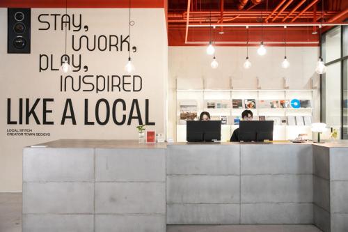an office with two people sitting at a desk at Local Stitch Creator Town Seogyo in Seoul