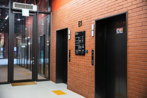 a brick wall with doors and a sign on it at Local Stitch Creator Town Seogyo in Seoul