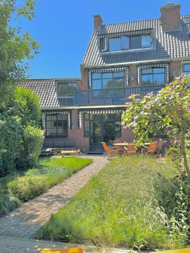 a large brick house with a patio in front of it at Luxury home in quiet neighbourhood near beach in The Hague