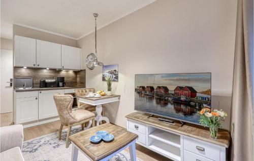 a living room with a large flat screen tv at Baltischer Hof Apartment 11 in Boltenhagen