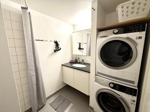 a bathroom with a washing machine and a sink at Spaniensgade 15A 1tv in Copenhagen