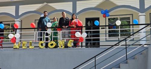 a group of people standing in front of a house at Hotel HBH Himalaya's Beautiful Hills in Uttarkāshi