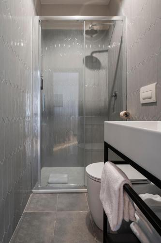 a bathroom with a shower and a toilet and a sink at Rome Ciampino Smart Hotel in Ciampino
