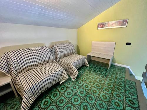 a bedroom with a bed and a couch and a table at La Scuna Apartment Monterosso in Monterosso al Mare