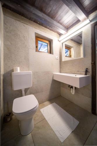 a bathroom with a white toilet and a sink at Camping Del Sole Village in Iseo