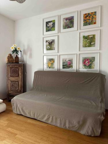 a bedroom with a bed with four pictures on the wall at Wellness Rental Vienna in Vienna