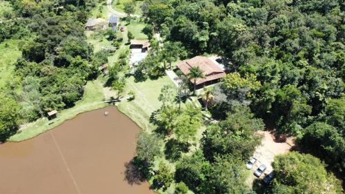 an aerial view of a house next to a river at Pousada Fazenda Bocaina in Inhaúma