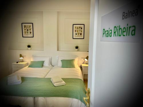 a bedroom with a white bed with green accents at Balnea Baiona in Baiona