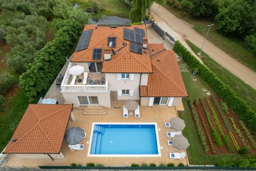 an aerial view of a house with a swimming pool at Villa Buroli with Pool, Sauna and Jacuzzi in Buroli