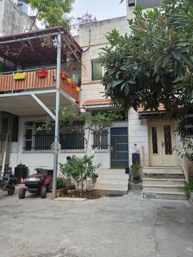 a house with a car parked in front of it at حنضلةHandala Guest House in Bethlehem