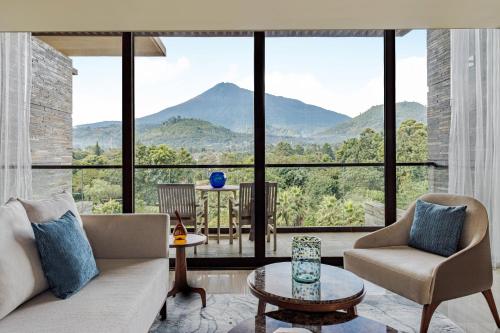 a living room with a view of mountains at Gran Melia Arusha in Arusha