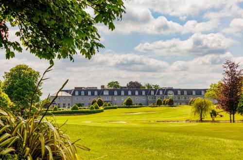 a view of a building on a golf course with a green at Mount Wolseley Hotel Spa & Golf Resort in Tullow