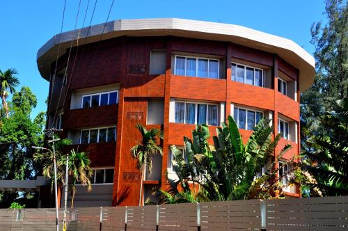 a red brick building with a round top at Sinclairs Bayview in Port Blair