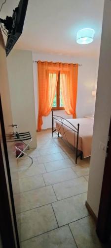 a bedroom with a bed with an orange curtain at B&B Vetralla in Fabriano