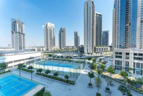 an aerial view of a tennis court in a city at Elegant Luxury Apartment with Stunning Lake Views in Dubai Creek Harbour By ĀYA Boutique in Dubai