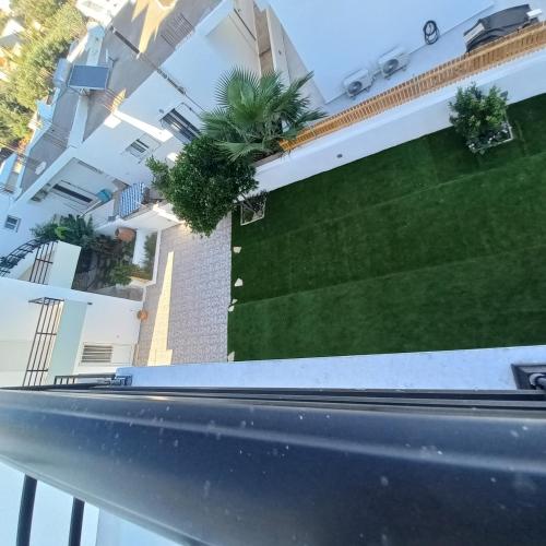 a view from the balcony of a building with plants at Central Rooms in Makry Gialos
