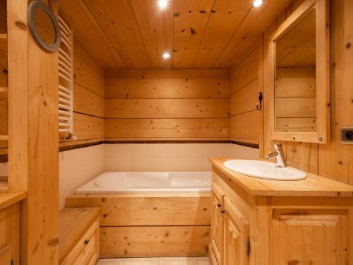 a bathroom with a tub and a sink at Chalet 4**** cosy, village, garage, WIFI - FR-1-304-21 in La Clusaz