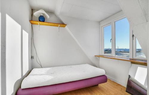 a small room with a bed and a window at Lovely Home In Thyborøn With Kitchen in Thyborøn