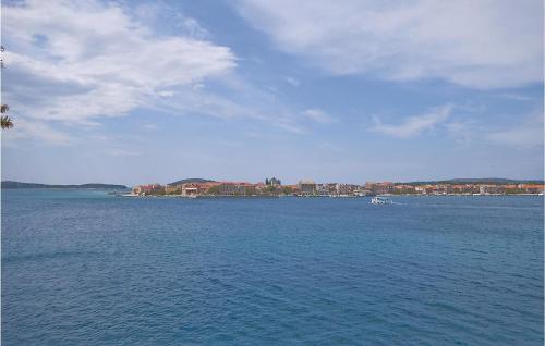 a large body of water with a boat in it at Apartment Sibenik With Sea View Xi in Krapanj