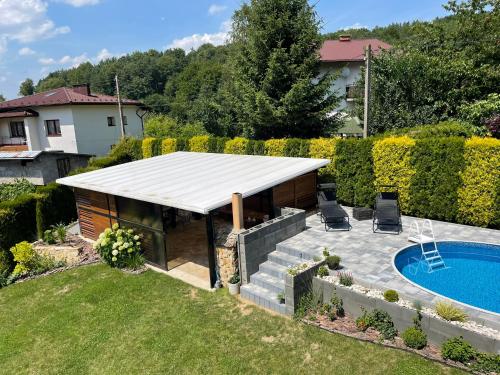 a backyard with a swimming pool and a pavilion at Pokoje Gościnne nad Rożnowskim in Gródek Nad Dunajcem