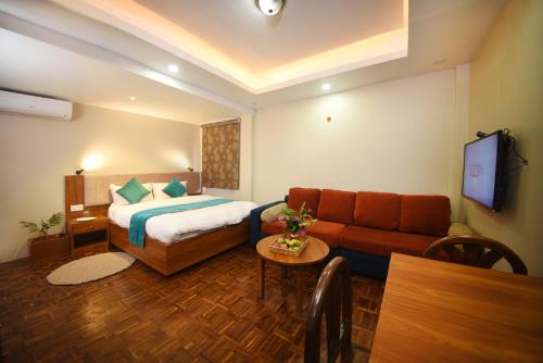 a hotel room with a bed and a couch at Mums Homestay & Studio Apartments in Kathmandu