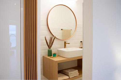 a bathroom with a sink and a mirror at JOELL Apartments in Lokva Rogoznica