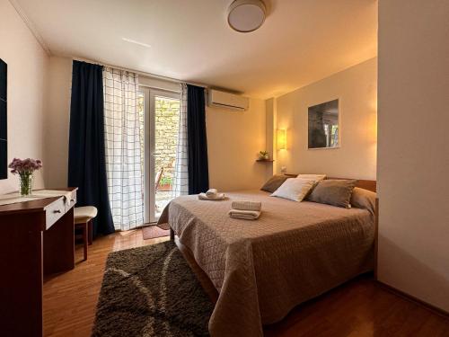 a bedroom with a bed and a window at Apartmani Barica in Novigrad Istria