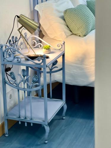 a blue night stand next to a bed at Balnea Baiona in Baiona