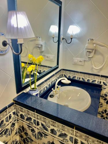 a bathroom with a sink and a mirror at Balnea Baiona in Baiona