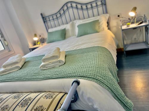 a bedroom with a large bed with towels on it at Balnea Baiona in Baiona