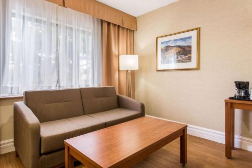 a living room with a couch and a coffee table at Quality Inn & Suites in Gatineau