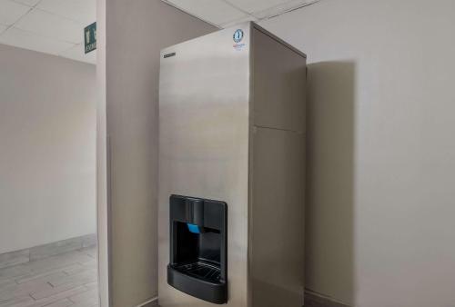 a stainless steel refrigerator in a wall in a room at Econo Lodge Inn & Suites Diamondhead in Diamondhead