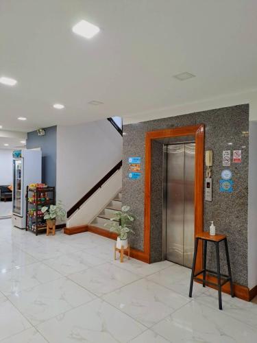 a hallway with a staircase and a door in a building at Windsor Hotel in Nakhon Phanom