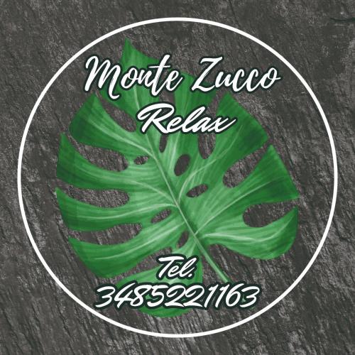 a green leaf on a plate with the words motive zucchini relax at Monte Zucco Relax self check in in San Pellegrino Terme