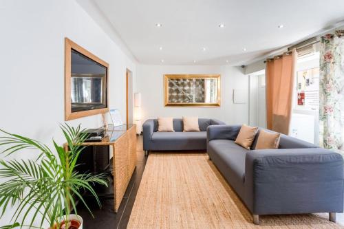a living room with two couches and a television at Casa 42 - Cozy & Fancy Boutique House in Barão de São João