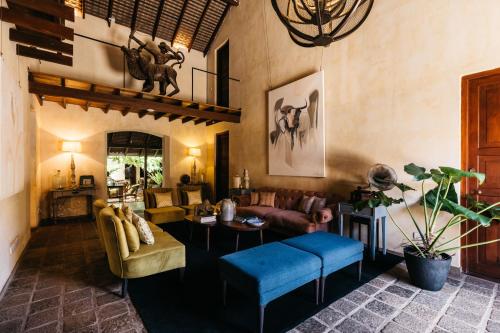 a living room with a couch and a table at The Bungalow Galle Fort - Hotel - Restaurant - Cocktail bar in Galle