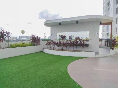 a balcony with green grass in a building at Modern and Nice 2BR at Patraland Urbano Apartment By Travelio in Bekasi