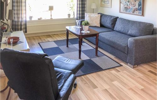 a living room with a couch and a table at Gorgeous Apartment In Tjurkö in Sturkö