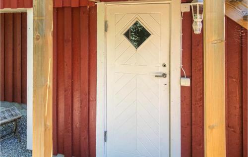 a white door with a window on a house at Gorgeous Apartment In Tjurkö in Sturkö